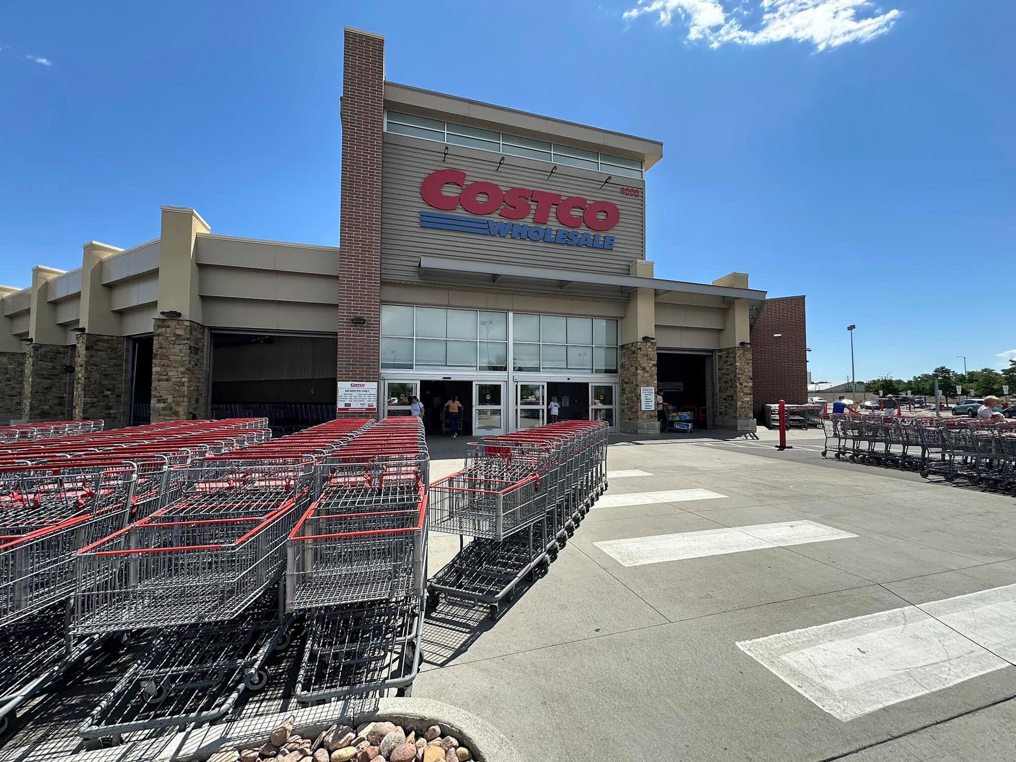 Rows of shopping carts at a Costco warehouse entrance.
