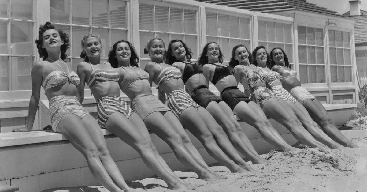 Women in bathing suits on a beach in 1949, used to illustrate changing summer-body culture.